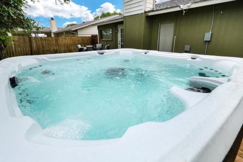 a jacuzzi tub in the backyard of a house at Near Sea World Hot Tub Swing Set BBQ Yard Games in San Antonio