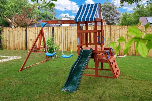 a playground with a slide in a yard at Near Sea World Hot Tub Swing Set BBQ Yard Games in San Antonio