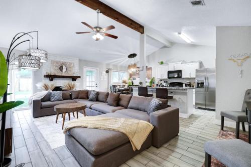 a living room with a couch and a kitchen at Near Sea World Hot Tub Swing Set BBQ Yard Games in San Antonio