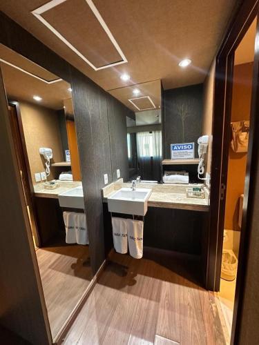 a large bathroom with two sinks and two mirrors at Flat 1638 on Ibirapuera Avenue in Moema - São Paulo in São Paulo