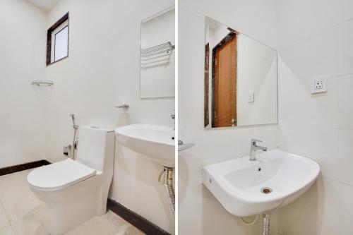 a white bathroom with a toilet and a sink at Townhouse OAK XOTEL near silk board metro in Bengaluru
