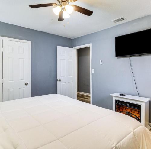a bedroom with a bed and a flat screen tv at Stunning, Pet-friendly Home in Savannah in Savannah