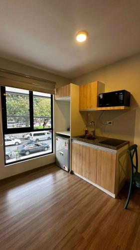 a kitchen with a sink and a window in a room at Lovely studio apartment in Cochabamba