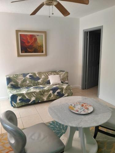 a living room with a couch and a table at Sunlight Apts in Mount Thompson