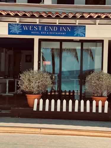 a fence in front of a west end inn at West end inn in West End