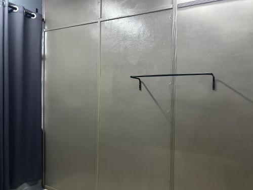 a shower stall with a glass door in a bathroom at MDF Payang Guesthouse in Kuala Terengganu