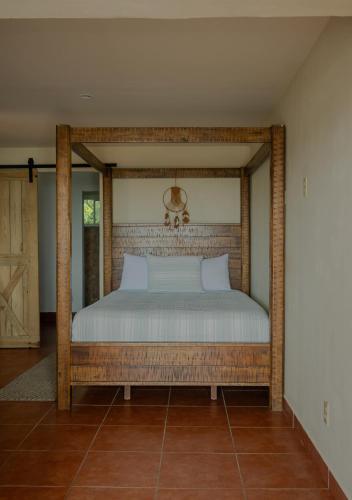 a bed with a wooden frame in a room at West end inn in West End