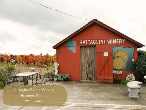 a red building with a table in front of it at Wine Country King Bed BBQ Stocked in Santa Rosa