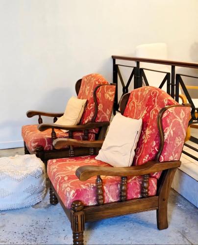 a couple of chairs sitting next to each other at Affordable & cosy, close to train station, CBD & Airport in Perth