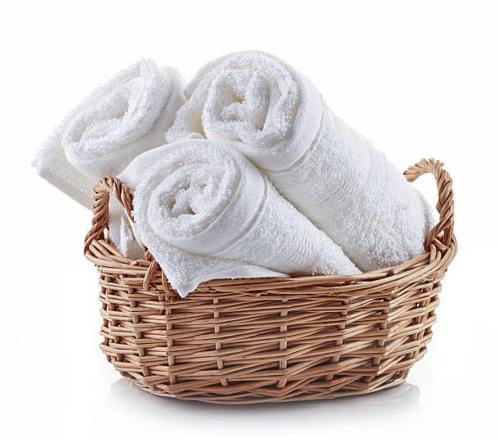 a basket filled with towels on a white background at One-Bedroom Suite Pool with Bath Kitchen in West Palm Beach in West Palm Beach