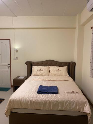 a bedroom with a bed with a blue towel on it at Boontorsub in Ban Khlong Samrong
