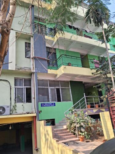 an apartment building with stairs and balconies at PRATISTHA Lodge in Guwahati