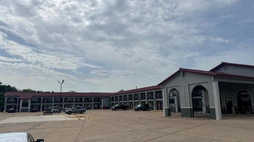 a large building with cars parked in a parking lot at Econo Lodge in Belton