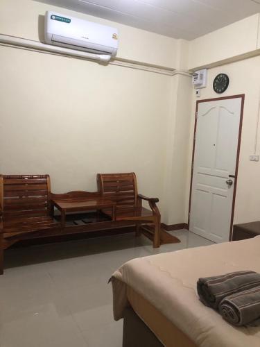 a room with two chairs and a couch and a heater at Boontorsub in Ban Khlong Samrong