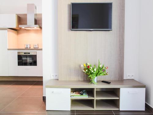 a living room with a tv on a wall at Villa Irene in Trenčianske Teplice
