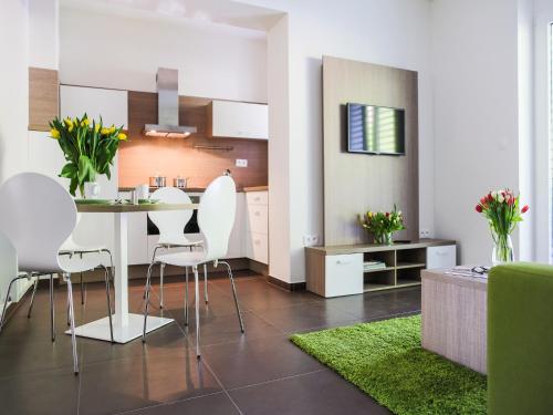 a kitchen and living room with a table and chairs at Villa Irene in Trenčianske Teplice
