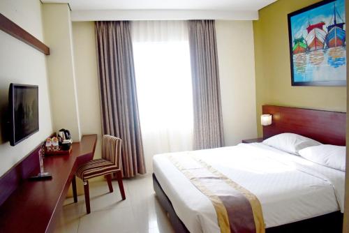 Katil atau katil-katil dalam bilik di Noormans Hotel Semarang