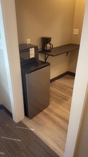 a kitchen with a microwave and a table in a room at Willow e-hotel in Mattoon