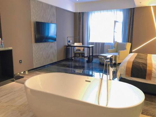 a bathroom with a large tub in a hotel room at Harbin Splendent Hotel in Harbin
