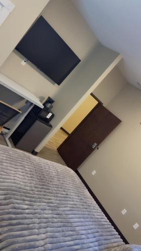 a bedroom with a bed and a flat screen tv at Willow e-hotel in Mattoon