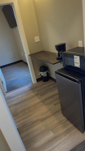 a kitchen with a stairway with a counter and a stove at Willow e-hotel in Mattoon