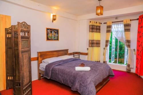 a bedroom with a bed with two towels on it at Single Tree Villa in Nuwara Eliya