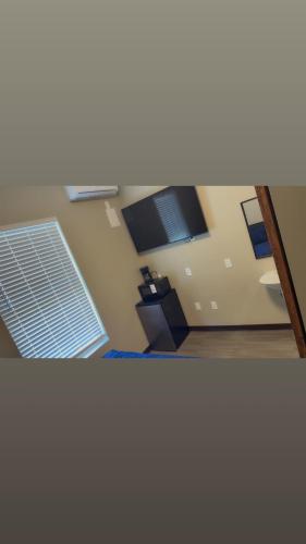 a room with a bathroom with a sink and windows at Willow e-hotel in Mattoon