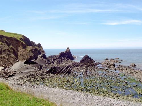 a rock formation on the beach near the ocean at The Square in Hartland