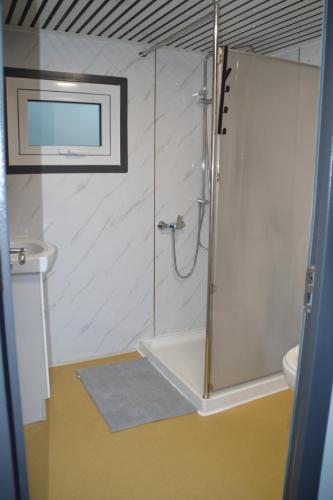 a bathroom with a shower and a toilet and a sink at Gallery Walk Getaway in Mount Tamborine