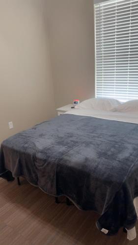 a bed with a blanket on it in a bedroom at Willow e-hotel in Mattoon