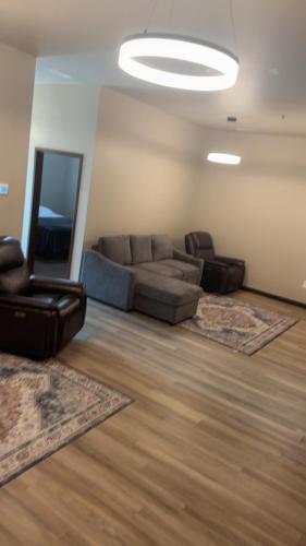 a living room with a couch and two chairs at Willow e-hotel in Mattoon