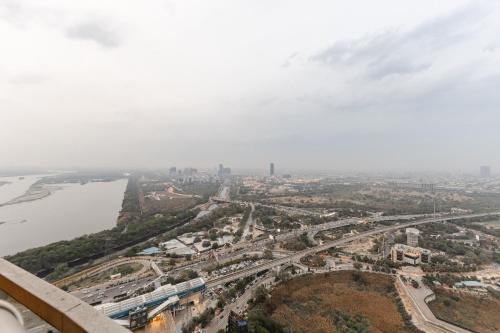 an aerial view of a city and a river at Cloud stays 36th floor in Noida