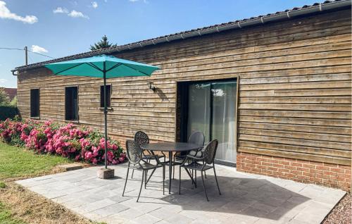 a table with chairs and an umbrella on a patio at Gorgeous Home In Gueschart With Kitchen in Gueschart
