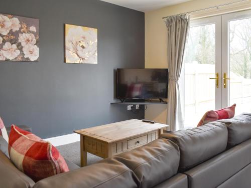 a living room with a couch and a coffee table at Four Dorchester Drive - Uk32042 in Inglewhite