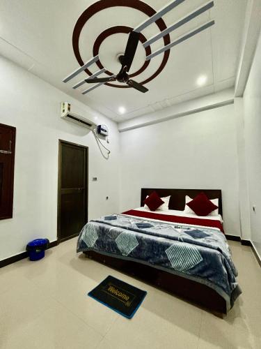 a bedroom with a bed and a ceiling fan at Welcome stay AC ROOM in Ayodhya