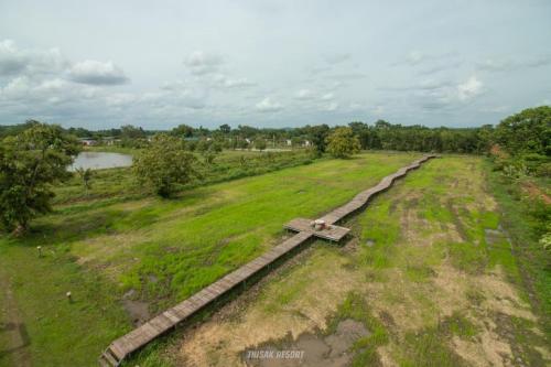 an old railroad track in a field of grass at Thisak Resort Cheung phnom kulen in Siem Reap