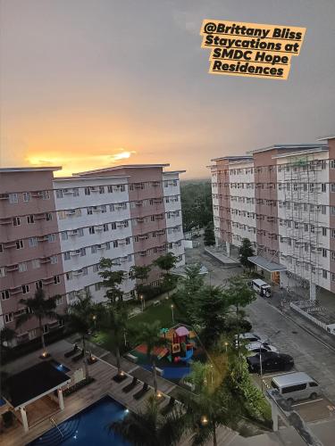 an overhead view of a large apartment building with a parking lot at Brittany Bliss Staycations at SMDC HOPE RESIDENCES in Trece Martires