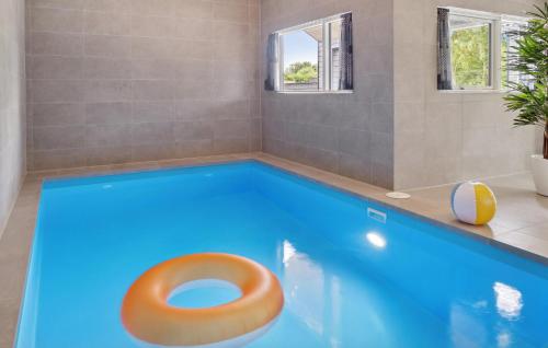 a bathroom with a swimming pool with a toilet in it at Amazing Home In Rødby With Wifi in Rødby