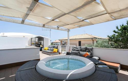 a hot tub sitting on top of a patio at Residenza Flamingo in Marzamemi