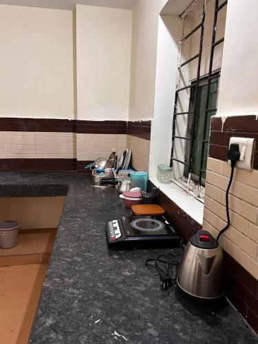 a room with a kitchen with a stove and a window at 3 Bhk Air Deck luxury apartment in Patna