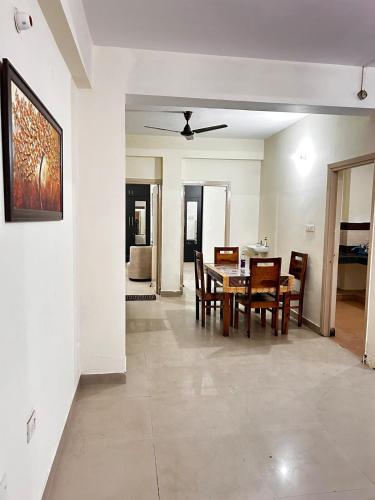 a dining room and living room with a table and chairs at 3 Bhk Air Deck luxury apartment in Patna