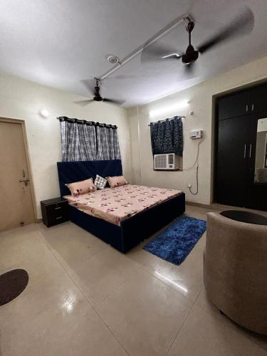 a bedroom with a bed and a ceiling fan at 3 Bhk Air Deck luxury apartment in Patna