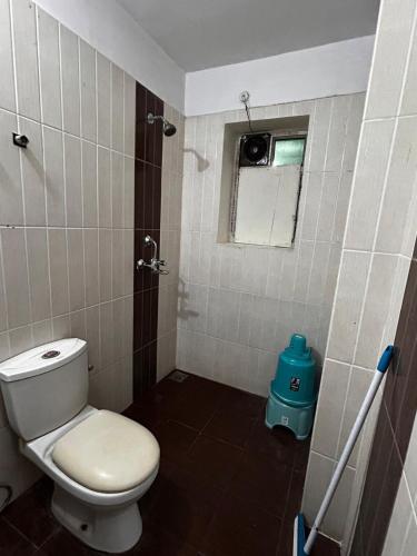 a small bathroom with a toilet and a window at 3 Bhk Air Deck luxury apartment in Patna