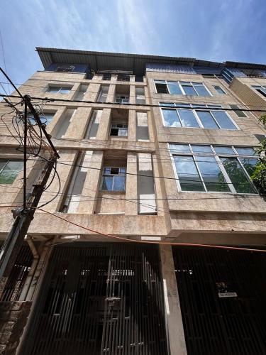 a tall brick building with windows and gates at 3 Bhk Air Deck luxury apartment in Patna