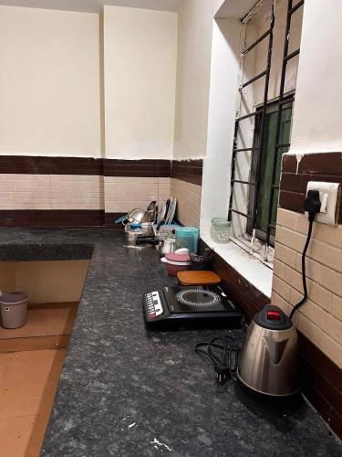 a kitchen with a stove and a sink in a room at 3 Bhk Air Deck luxury apartment in Patna