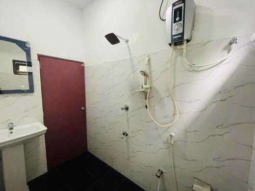 a bathroom with a shower with a shower head on the wall at Sholay Villa in Galle