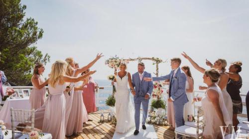 a bride and groom walking down the aisle with their wedding party at Exclusive Seafront Villa,Private Pool,Gym,BBQ in El Toro