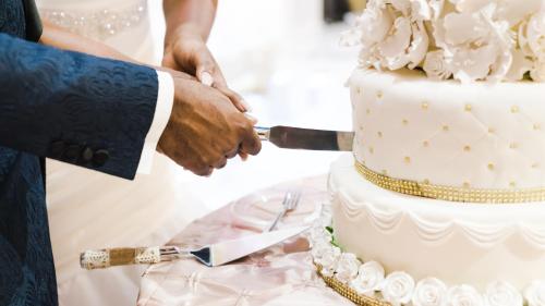 a bride and groom cutting their wedding cake at Exclusive Seafront Villa,Private Pool,Gym,BBQ in El Toro