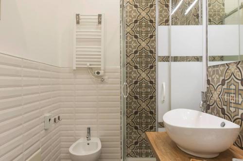 a bathroom with a white tub and a toilet at b&b don Mimì in Naples