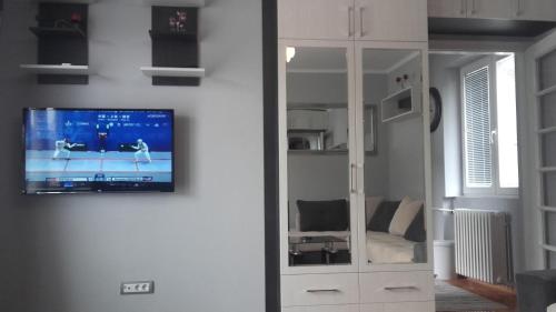 a living room with a tv on a wall at House Prljevic in Užice